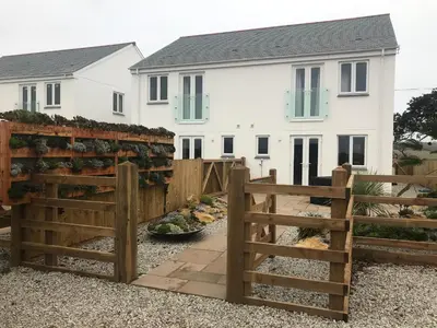 a wooden fence in front of a house at The Woodland Collection, 10 mins from beaches in Hayle