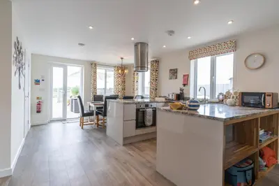 a kitchen and dining room with a counter top at The Woodland Collection, 10 mins from beaches in Hayle