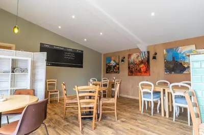 a restaurant with tables and chairs and a chalkboard at The Woodland Collection, 10 mins from beaches in Hayle