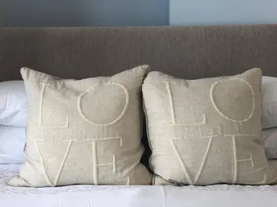 a couple of pillows sitting on top of a bed at Newquay Escape, 5 spacious ensuite bedrooms & parking- Simplycheckin in Newquay