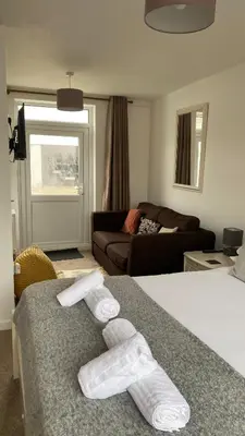 a room with a bed with towels on it at Uplands B and B in St Ives