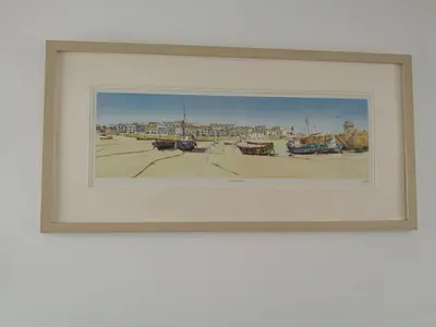 a framed painting of a harbor with boats at Uplands B and B in St Ives