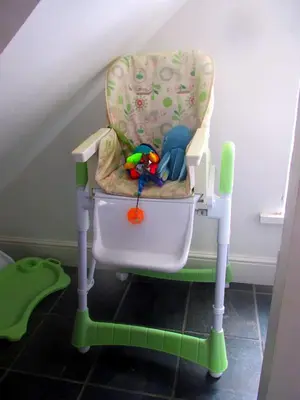 a baby high chair with toys sitting in it at Uplands B and B in St Ives