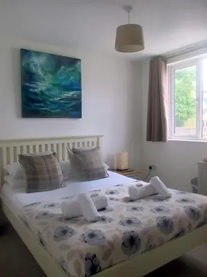 a bedroom with a bed with towels on it at Uplands B and B in St Ives