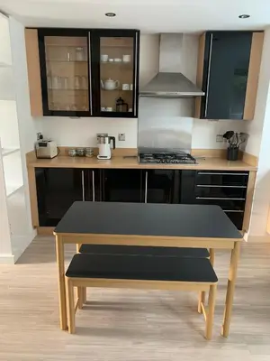 a kitchen with a table and a stove at The Apartment Boscawen Woods in Truro