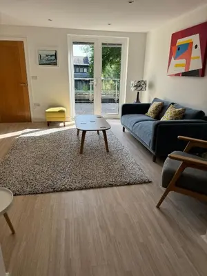 a living room with a couch and a coffee table at The Apartment Boscawen Woods in Truro