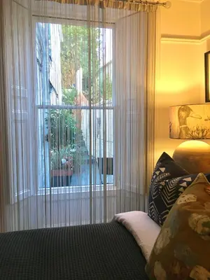 a bedroom with a window with a view of a yard at 'the inlet' falmouth in Falmouth