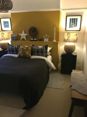 a bedroom with a bed with a black comforter at 'the inlet' falmouth in Falmouth