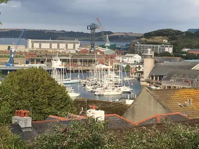 a group of boats docked in a harbor at 'the inlet' falmouth in Falmouth