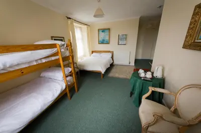 a room with two bunk beds and a table at The White Hart Hotel in Hayle