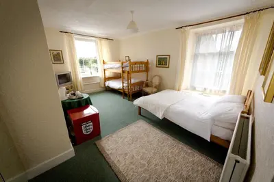 a bedroom with a bed and a window at The White Hart Hotel in Hayle
