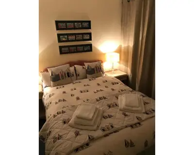 a bedroom with a bed with towels on it at Villa 7 Lanteglos, Camelford, Cornwall in Camelford
