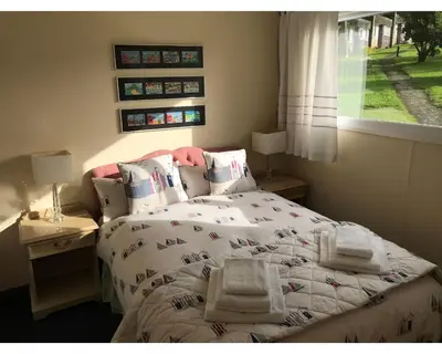 a bedroom with a bed with towels on it at Villa 7 Lanteglos, Camelford, Cornwall in Camelford