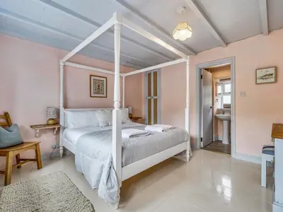 a bedroom with a white canopy bed in a room at New England-Uk12750 in Menheniot