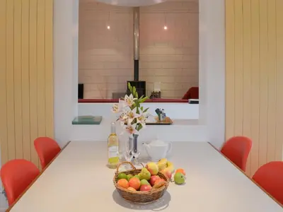 a table with a basket of fruit on it at Moderno-Uk12748 in Menheniot