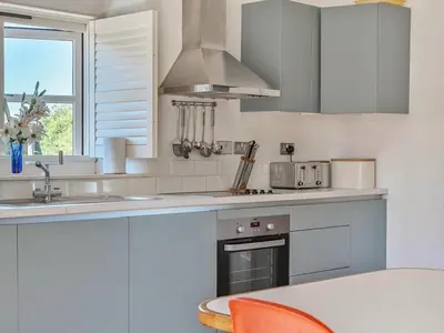 a kitchen with a sink and a stove top oven at Moderno-Uk12748 in Menheniot