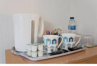 a tray with cups and a tea set on a counter at Tredara Bed & Breakfast in Truro