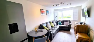 a living room with a couch and a table at 2 Rosemullion in Perranporth