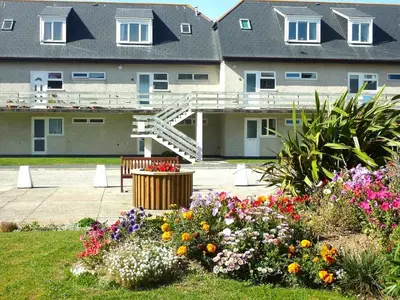a group of flowers in front of a building at 2 Rosemullion in Perranporth