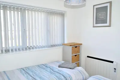 a bedroom with a bed and a window at 2 Rosemullion in Perranporth