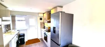 a kitchen with a stainless steel refrigerator at 2 Rosemullion in Perranporth