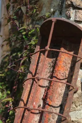 an old rusted metal object on the side of a building at The Wood Shed in Truro