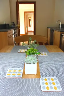 a table with a blue table cloth and two plates on it at Hooters Apartment EV Point in Wadebridge