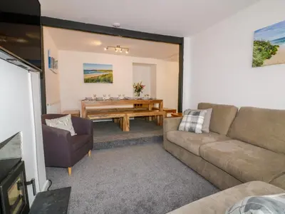 a living room with a couch and a table at Fistral Quay in Newquay