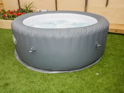 a large inflatable hot tub in the grass at Fistral Quay in Newquay