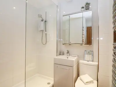 a bathroom with a toilet and a sink and a shower at Offshore in Porthtowan