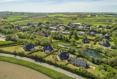 an aerial view of a village with houses and a river at The Summerhouse in Polzeath