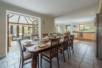 a kitchen and dining room with a table and chairs at The Summerhouse in Polzeath