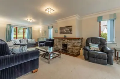 a living room with two couches and a fireplace at The Summerhouse in Polzeath