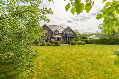 a large house with a large yard with green grass at The Summerhouse in Polzeath