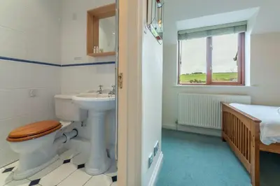 a bathroom with a toilet and a sink at The Summerhouse in Polzeath