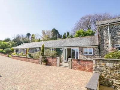 an old stone house with a brick driveway at FernGully in Saint Columb Major