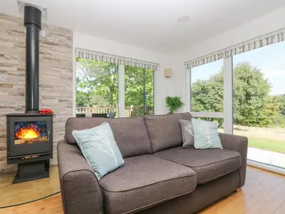 a living room with a couch and a fireplace at Willow in Truro