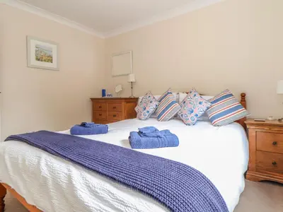 a bedroom with a bed with blue towels on it at Deja Blue in Falmouth