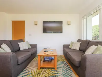 a living room with two couches and a coffee table at Rowan in Truro
