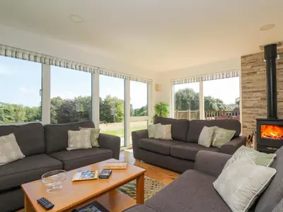 a living room with couches and a fireplace at Rowan in Truro