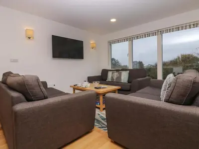 a living room with two couches and a table at Oak in Truro