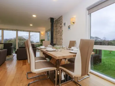 a dining room with a table and chairs at Oak in Truro