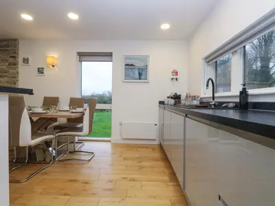 a kitchen with a dining table and a counter top at Oak in Truro