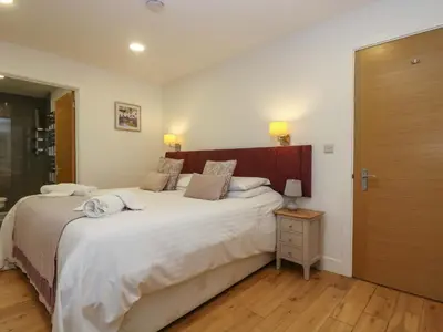 a bedroom with a large bed and a wooden headboard at Oak in Truro