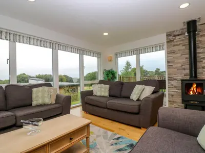 a living room with two couches and a fireplace at Maple in Truro