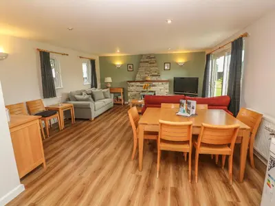 a living room with a table and chairs and a couch at 64 Waterside in Bodmin