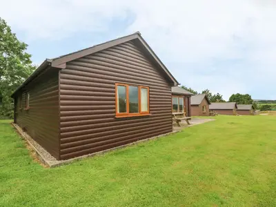 a small black house with a grass yard at 64 Waterside in Bodmin