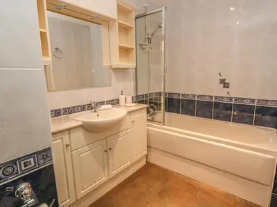 a bathroom with a sink and a shower and a tub at 64 Waterside in Bodmin