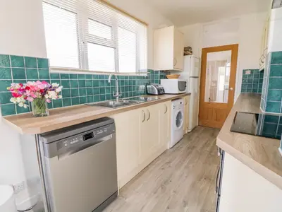 a kitchen with a sink and a dishwasher at Senafe in Bude