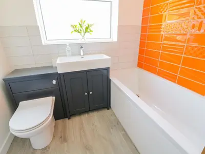 a bathroom with a sink and a toilet and a tub at Senafe in Bude
